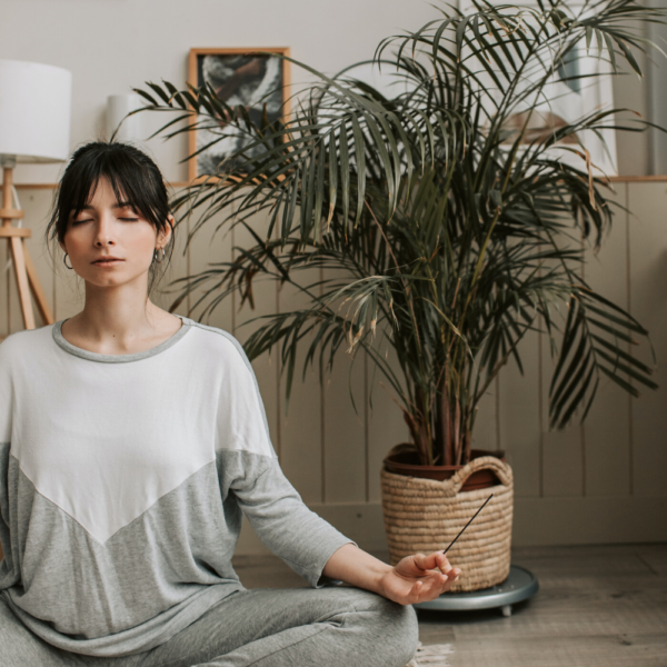 women meditating in her meditation or zen room in her house or small apartment