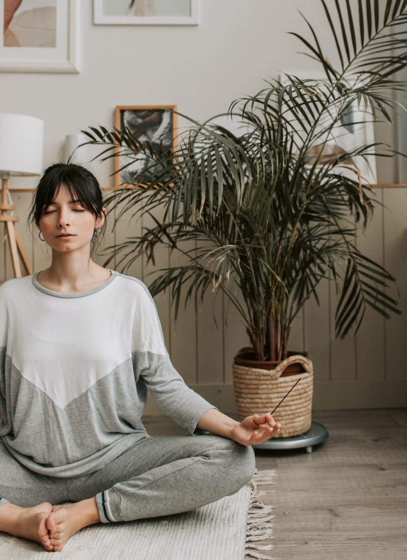 women meditating in her meditation or zen room in her house or small apartment