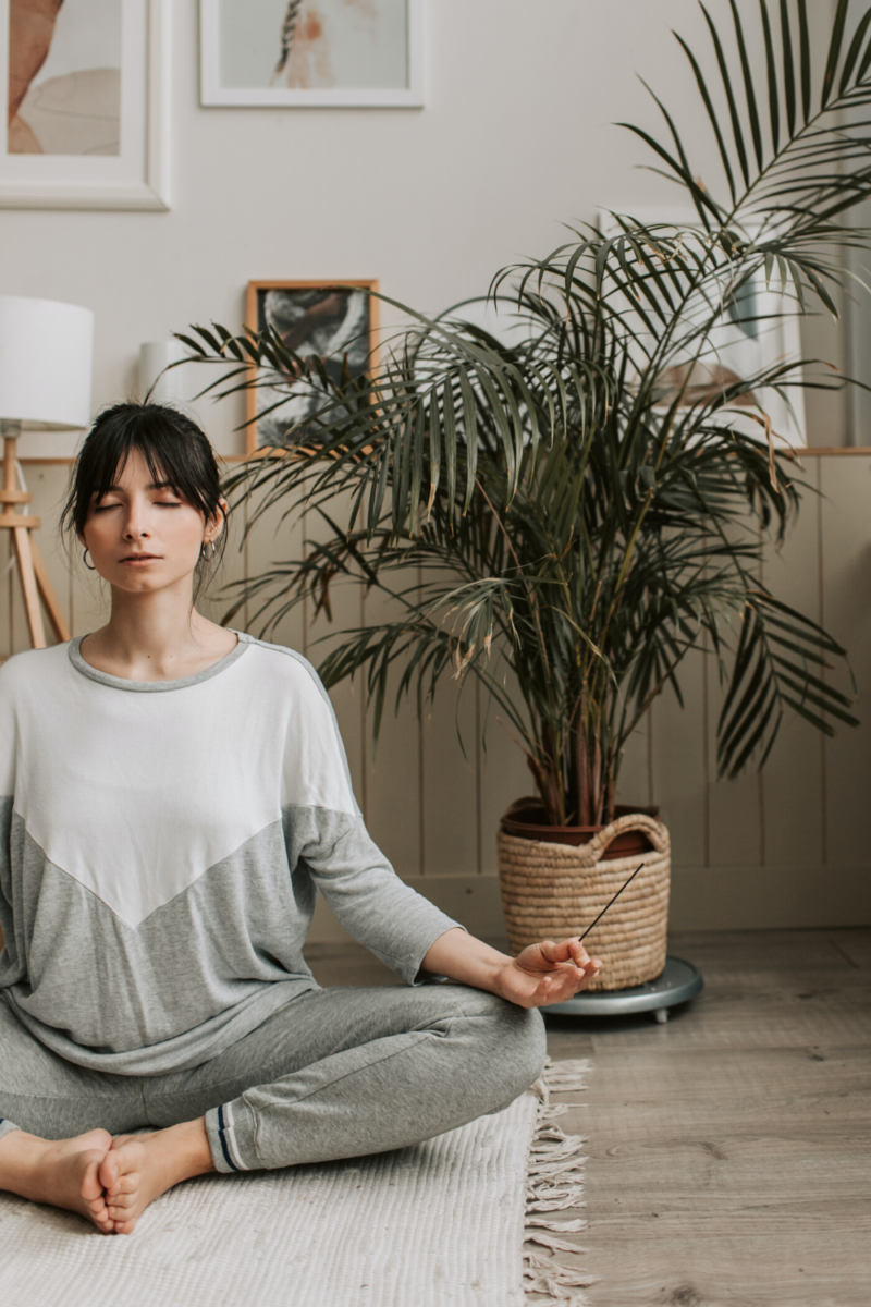 women meditating in her meditation or zen room in her house or small apartment