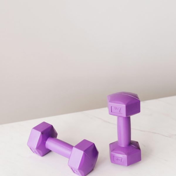 Photo of two small purple weights. This image is for a blog post called How to start working out consistently as a beginner