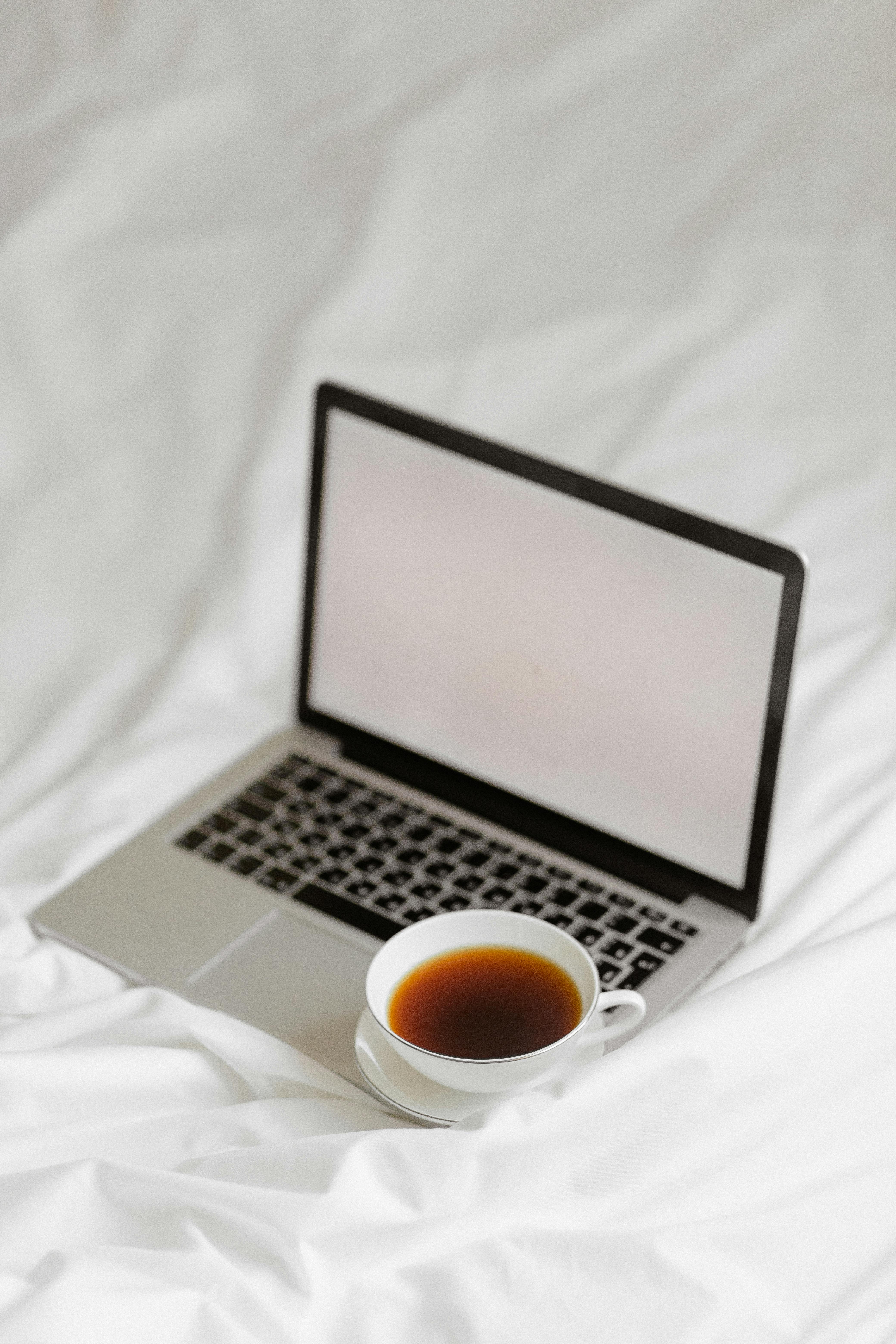 Photo shows a cup of coffee and a laptop on top of a web. This is for a blog about starting a blog in your 30s 