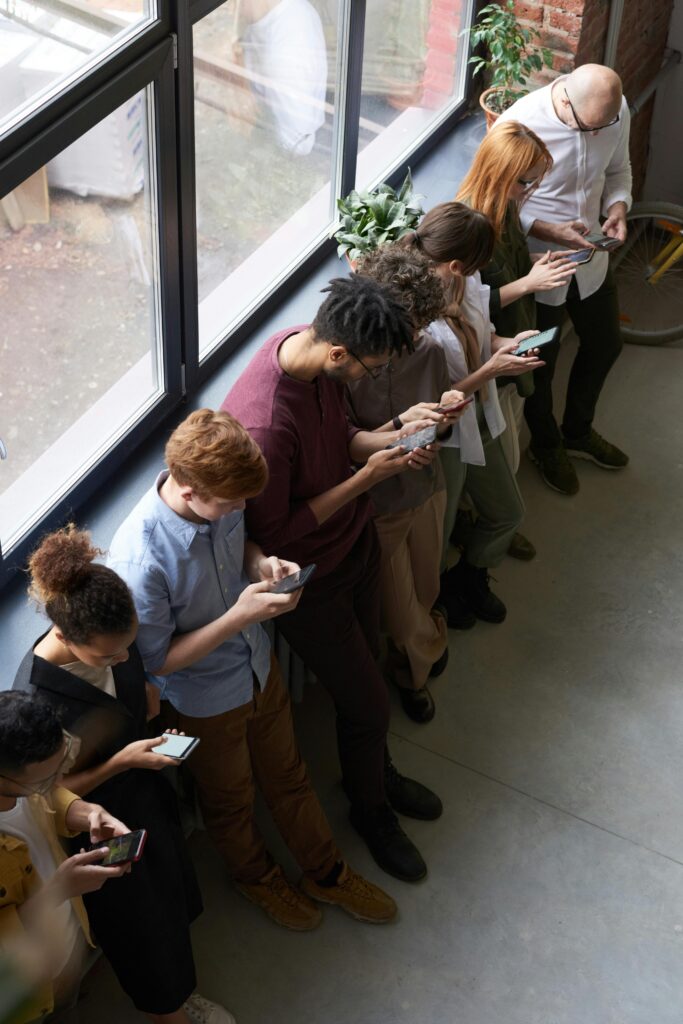 group of People looking scrolling in their phones