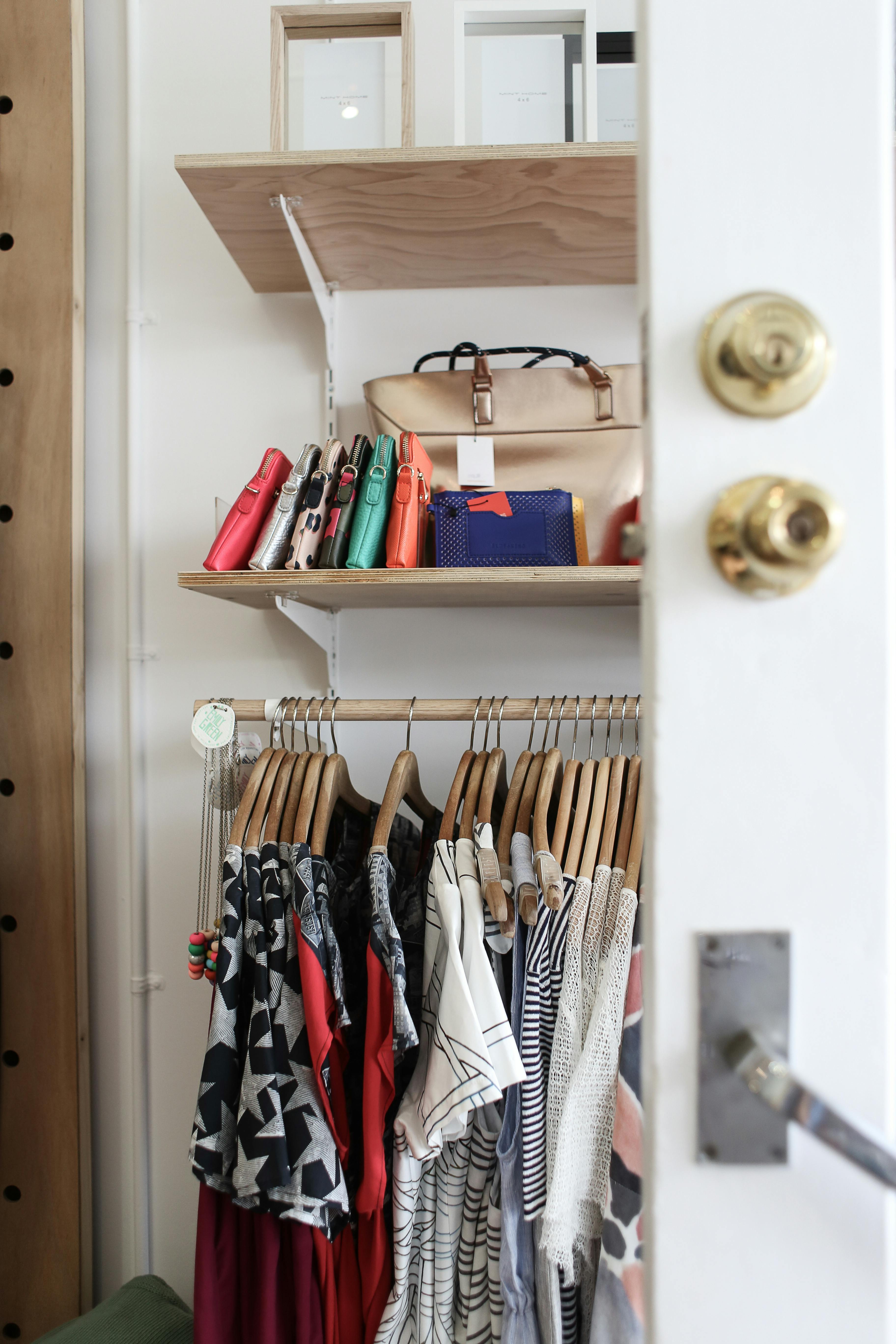 A picture of a closet overflowing with clothes