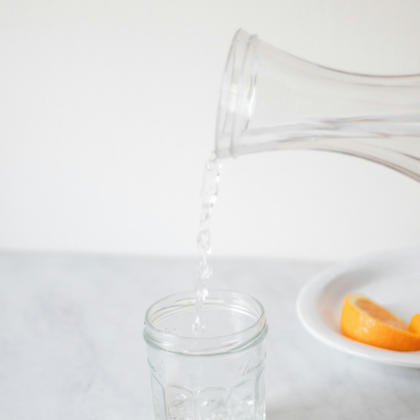 This image shows someone pouring water into a glass